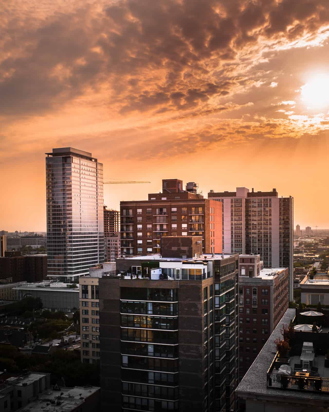 High-rise apartment buildings in a city skyline at sunset