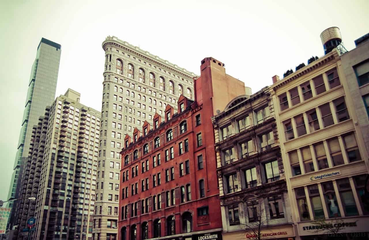 Row of older mid-rise apartment and commercial buildings along a city street