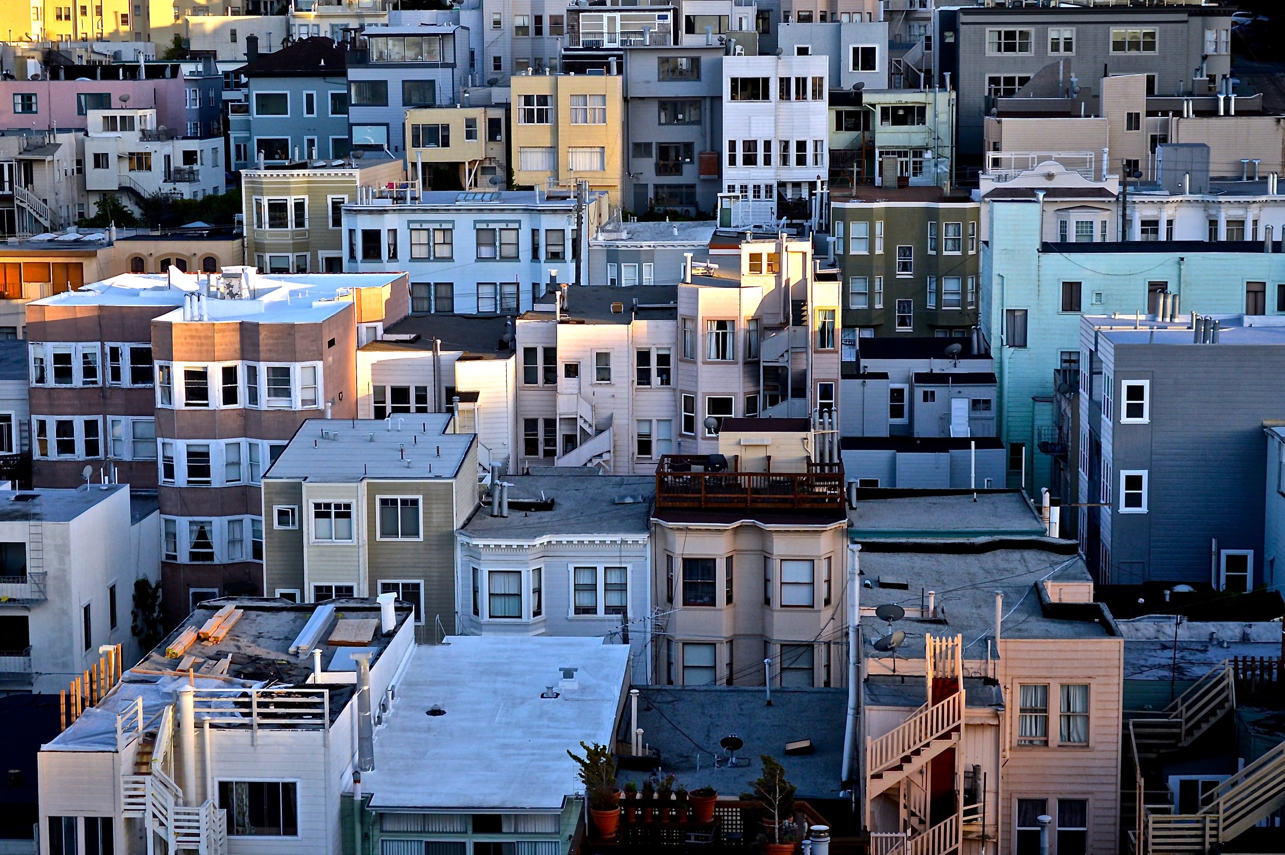 Hillside neighborhood of low-rise apartment buildings at sunset